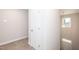 Hallway with carpeted floors, door and view of two-story foyer at 807 E Harnett St, Dunn, NC 28334
