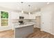 Kitchen with white shaker cabinets, granite countertops, and an island at 807 E Harnett St, Dunn, NC 28334
