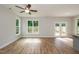 Living room with wood-look flooring and large windows at 807 E Harnett St, Dunn, NC 28334