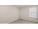 Well-lit bedroom featuring light walls, carpet, and a large window at 900 Canis Minor Rd, Wendell, NC 27591