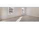 Well-lit bedroom with carpet flooring and two large windows at 900 Canis Minor Rd, Wendell, NC 27591