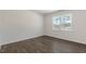 Simple bedroom with hardwood floors and a large window at 900 Canis Minor Rd, Wendell, NC 27591