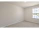 Simple bedroom with light walls, carpet flooring, and a window with wooded views at 900 Canis Minor Rd, Wendell, NC 27591
