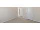 Spacious bedroom with neutral walls, carpet flooring, and access to a hallway at 900 Canis Minor Rd, Wendell, NC 27591