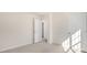 Bright bedroom with neutral walls and carpet, featuring multiple doors and a window at 900 Canis Minor Rd, Wendell, NC 27591