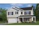 Two-story house with gray siding, brick accents, and a two-car garage at 928 Canis Minor Rd, Wendell, NC 27591