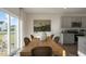 Open concept kitchen and dining area with modern gray cabinets and granite countertops at 928 Canis Minor Rd, Wendell, NC 27591
