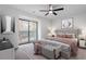 Main bedroom with a king-size bed, sliding door to balcony, and ceiling fan at 1016 N Bend Dr, Raleigh, NC 27609