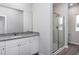 Bathroom with granite vanity, frameless shower, and window at 11300 International Dr, Middlesex, NC 27557