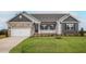 Newly constructed home with stone accents and a two-car garage at 11300 International Dr, Middlesex, NC 27557