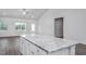 Modern kitchen island with granite countertops and white cabinets at 11300 International Dr, Middlesex, NC 27557
