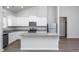 Open concept kitchen with island and stainless steel appliances at 11300 International Dr, Middlesex, NC 27557