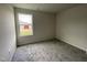 Simple carpeted bedroom with a window overlooking the street at 130 Tulipfield Way, Benson, NC 27504