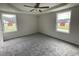 Spacious main bedroom with two windows and carpet flooring at 130 Tulipfield Way, Benson, NC 27504