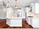 Bright kitchen with white cabinets, marble countertops, and hardwood floors at 3000 Dogwood Valley Ct, Raleigh, NC 27616