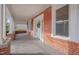 Charming front porch with white columns, brick exterior, and a white front door at 301 E Umstead St, Durham, NC 27707