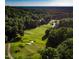 Aerial view of golf course with pond and trees at 32520 Archdale Dr, Chapel Hill, NC 27517