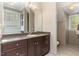 Dark wood vanity, large mirror, and tile flooring at 32520 Archdale Dr, Chapel Hill, NC 27517