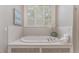 Relaxing bathroom with a large soaking tub and window at 32520 Archdale Dr, Chapel Hill, NC 27517