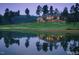 Luxury clubhouse overlooking a golf course and lake at sunset at 32520 Archdale Dr, Chapel Hill, NC 27517