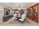 Formal dining room with a large table, built-in cabinetry, and hardwood floors at 32520 Archdale Dr, Chapel Hill, NC 27517