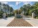 Impressive entrance to Governors Club with stone pillars and landscaping at 32520 Archdale Dr, Chapel Hill, NC 27517