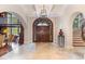 Elegant entryway with double doors, high ceilings, and curved staircase at 32520 Archdale Dr, Chapel Hill, NC 27517
