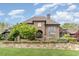 Grand brick home with manicured lawn and stone wall at 32520 Archdale Dr, Chapel Hill, NC 27517