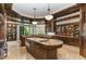 Gourmet kitchen boasts expansive island, granite countertops, and ample cabinetry at 32520 Archdale Dr, Chapel Hill, NC 27517