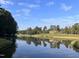Scenic lake view with clubhouse in background at 32520 Archdale Dr, Chapel Hill, NC 27517