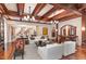 Open living room showcasing hardwood floors, a fireplace, and a view into dining area at 32520 Archdale Dr, Chapel Hill, NC 27517