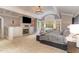 Spacious main bedroom with fireplace, large windows, and a sitting area at 32520 Archdale Dr, Chapel Hill, NC 27517