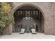Large brick patio with arched entry and seating area at 32520 Archdale Dr, Chapel Hill, NC 27517