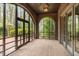 Brick screened porch with arched windows and brick flooring at 32520 Archdale Dr, Chapel Hill, NC 27517