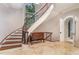 Stunning curved staircase with ornate railings in entryway at 32520 Archdale Dr, Chapel Hill, NC 27517