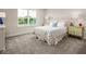 Spacious bedroom with large window, full bed, and patterned bedding at 604 Mohinda Way, Willow Springs, NC 27592