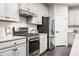 Modern kitchen with stainless steel appliances and granite countertops at 604 Mohinda Way, Willow Springs, NC 27592