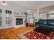 Fireplace with white mantel in a living room with hardwood floors at 6625 Arbor Grande Way, Raleigh, NC 27615