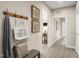 Inviting entryway with a bench, coat rack, and decorative wall art at 8913 Stratus St, Willow Springs, NC 27592