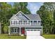 Two-story house with gray siding, white trim, and a red door at 8913 Stratus St, Willow Springs, NC 27592