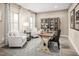 Bright home office features two armchairs, a large desk, and built-in shelving at 8913 Stratus St, Willow Springs, NC 27592