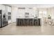 Modern kitchen with white cabinets, stainless steel appliances, and an island at 8913 Stratus St, Willow Springs, NC 27592