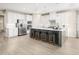 Modern kitchen with white cabinets, stainless steel appliances, and an island at 8913 Stratus St, Willow Springs, NC 27592