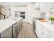 Modern kitchen with white cabinets and stainless steel appliances at 8913 Stratus St, Willow Springs, NC 27592