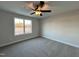 Well-lit bedroom with carpet and large window overlooking backyard at 91 Calluna Dr, Clayton, NC 27520