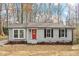 Newly renovated Ranch home with gray siding, red door, and landscaped yard at 107 Crystal Ct, Cary, NC 27513