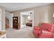 Red chair, bookcase, and view into bedroom with red bedding at 108 Timber View Ln, Cary, NC 27511