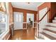 Hardwood floor entryway with staircase and view into living room at 108 Timber View Ln, Cary, NC 27511