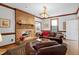 Living room with brick fireplace and leather seating at 108 Timber View Ln, Cary, NC 27511