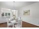 White dining room with chandelier and view to kitchen at 113 Granby Ct, Cary, NC 27511